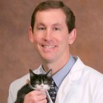 Dr. Riedel holding a cat